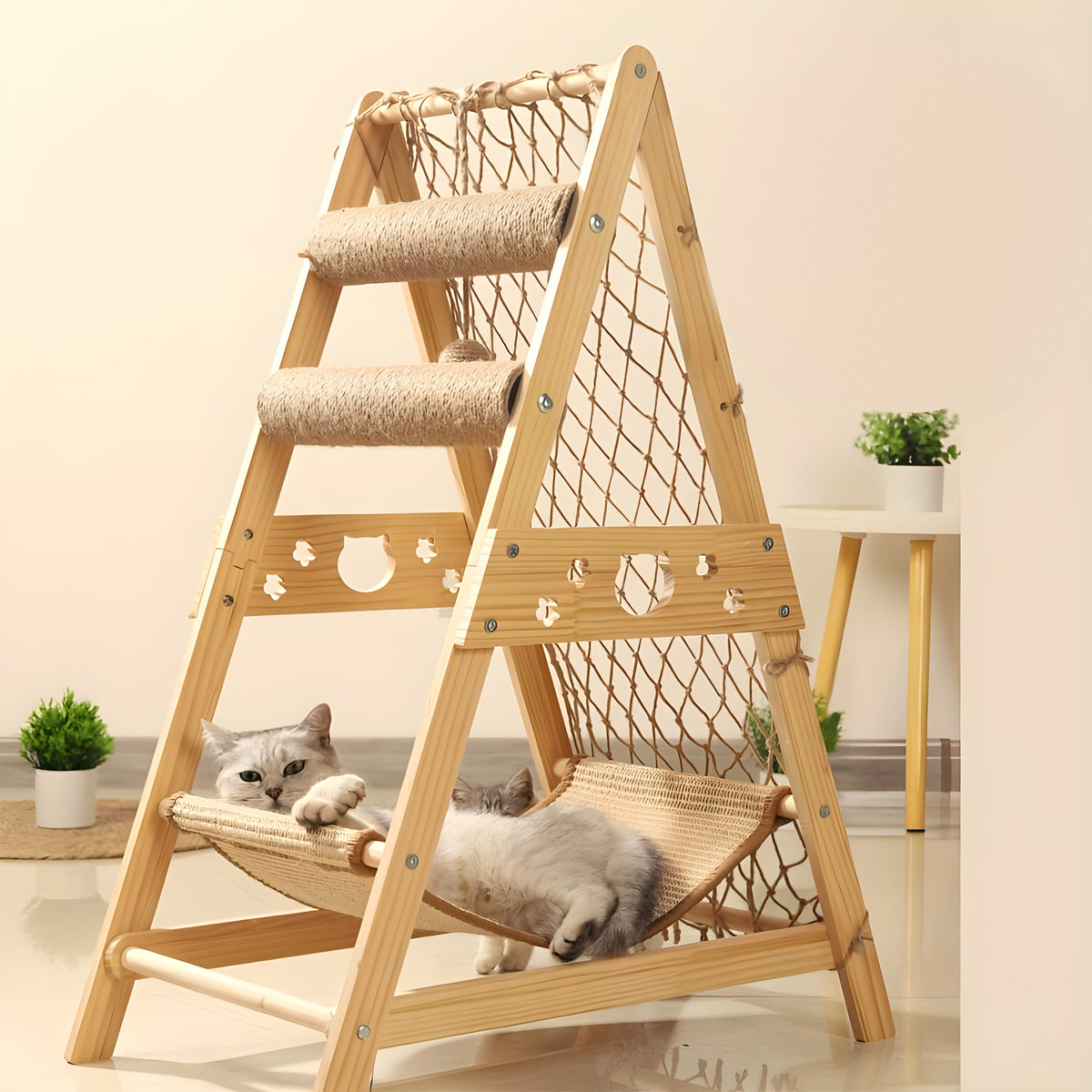 Two cats lounging in the hammock of a natural wood A-frame cat tree with climbing net
