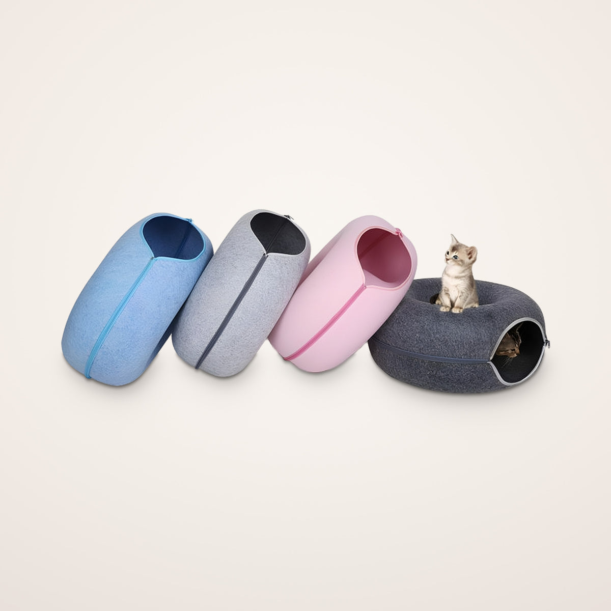 Felt cat caves in sky blue, light gray, light pink and dark gray with kittens playing in a donut tunnel bed