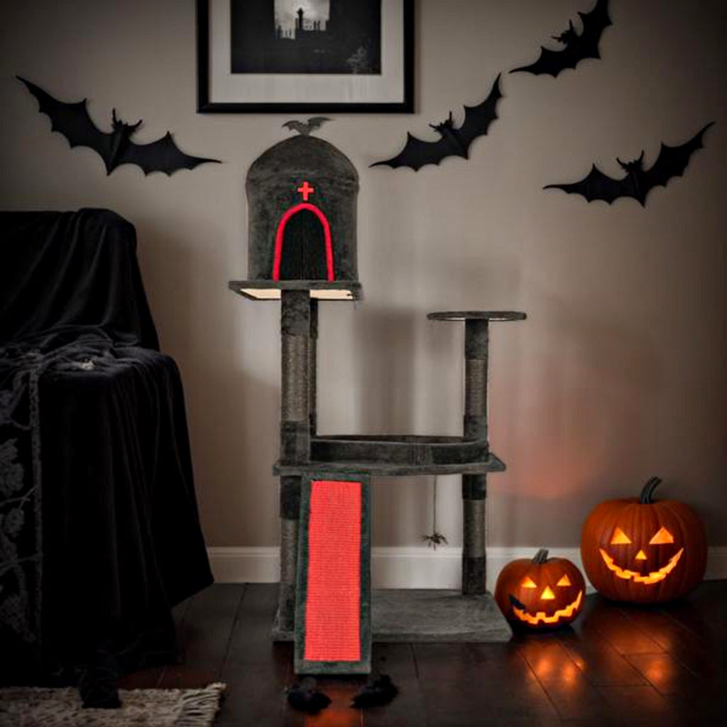 Gothic cat tree styled for Halloween with pumpkins and bats